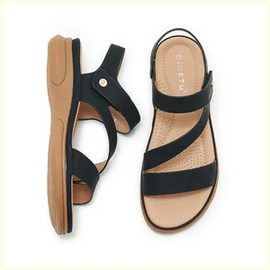 Macro detail of breathable perforated footbed and stitching on black wedge sandals