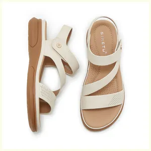Top view of beige wedge sandals featuring three criss-cross straps and elastic heel support