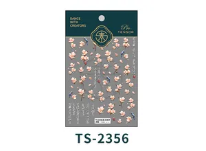 Detailed macro view of 5D embossed magnolia and bird nail art stickers with calligraphy