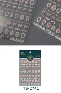 Detailed macro view of 3D embossed nail stickers with teddy bear and lace designs