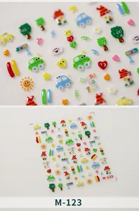 Detailed macro view of 3D cartoon nail stickers with raised textures and colorful patterns
