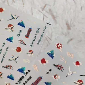 Japanese style nail art stickers with golden cranes, clouds, and traditional towers
