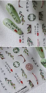 Close-up of 5D embossed nail stickers featuring Chinese calligraphy and herbal patterns