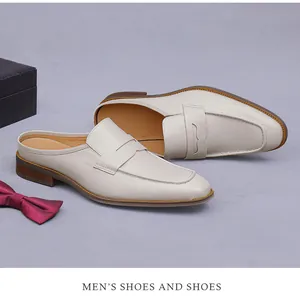 Detail view of cream leather penny loafer mules with wood texture sole and smooth finish