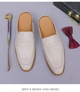 Top view of cream leather mule loafers with moccasin stitching and elegant props