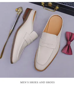 Detailed shot of cream leather loafer mules with wood grain heels and refined stitching
