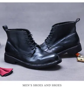 Classic black leather men's wingtip boots with lace-up detail and polished leather finish
