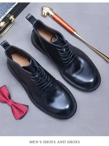 Classic black leather boots paired with professional business accessories and a cane