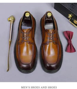 Top view of premium brown leather oxfords with burnished toe and business accessories