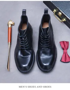 Top view of premium black leather men's wingtip boots with a classic round toe design