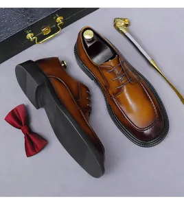 Detail view of brown gradient leather derby shoes with matching gift box and bow tie set