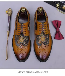 Top view of brown leather brogue shoes with gold floral embroidery and premium shoe horn