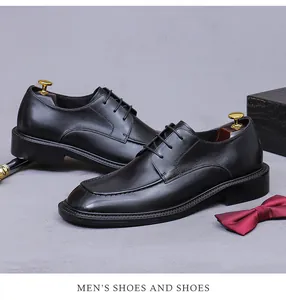 Detail of premium black leather men's dress shoes with U-tip stitching and wood shoe trees