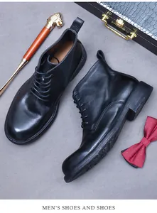 Classic black leather work boots with cane and bow tie in a gentleman lifestyle setting