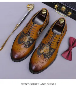 Close-up of brown Brogue leather shoes with gold floral embroidery and classic carving