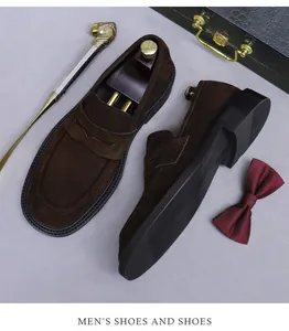 Macro detail of dark brown suede loafers with penny strap and cedar shoe trees