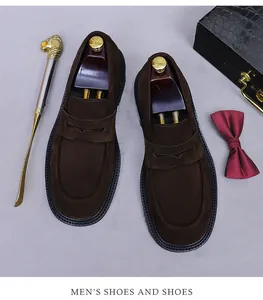 Close-up of premium dark brown suede loafers featuring luxury wooden shoe trees and accessories