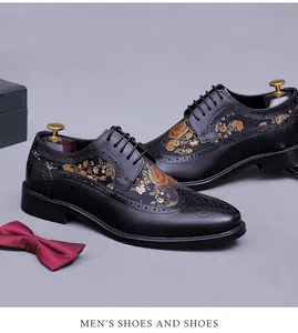Macro view of black leather Oxford shoes featuring gold floral embroidery and Brogue details