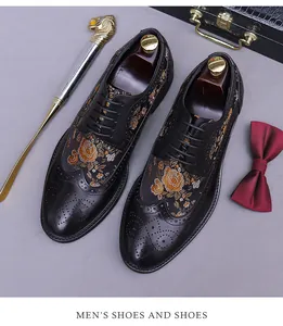 Close-up of black Brogue shoes with gold rose embroidery and intricate wingtip detailing