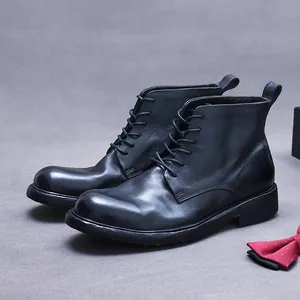 Classic black leather Goodyear welted wingtip work boots for men with lace-up style
