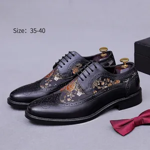Women's black leather brogue shoes with gold floral embroidery and wingtip detailing
