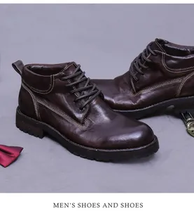 Detail of dark brown leather work boots with vintage texture and double stitching