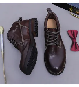 Close-up of vintage leather work boots with white contrast stitching and thick lug sole