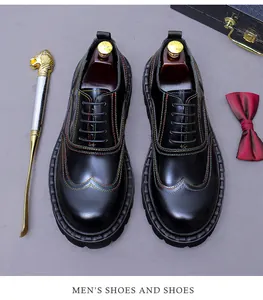 Close-up of black leather oxford shoes featuring multi-color stitching and wingtip detail