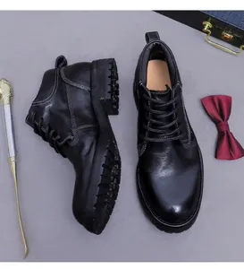 Detail of premium black leather boots with white stitching and luxury accessories