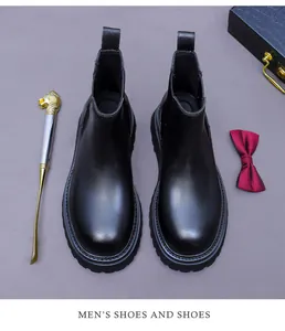 Classic black leather Chelsea boots displayed with refined gentleman accessories