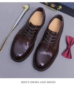 Bovenaanzicht van donkerbruine lederen Derby-schoenen met stiksels en zakelijke accessoires
