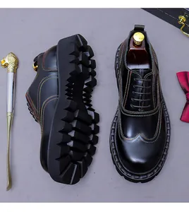 Close-up of black platform leather oxfords featuring vibrant multi-color stitching details