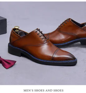 Close-up of brown leather dress shoes with blue stitching and gradient toe detail