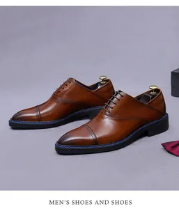 Detail of brown leather oxford shoe with blue stitching and gradient toe finish