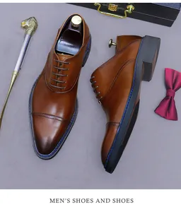 Detailed close-up of brown leather cap-toe oxfords with decorative blue sole stitching
