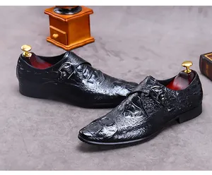 Macro detail of black crocodile-embossed leather monk strap shoe with silver buckle