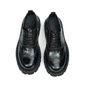 Macro detail of black brogue shoes with vibrant rainbow stitching and wingtip patterns