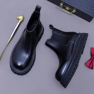 Classic black leather Chelsea boots for men with thick lug soles and elastic side panels
