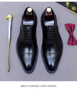 Top view of premium leather cap toe Oxford shoes with shoe trees and accessories