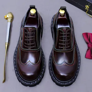 Mens dark brown leather wingtip oxford shoes with brogue details and thick rubber soles