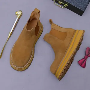 Brown suede Chelsea boots for men with thick lug soles and British style aesthetic