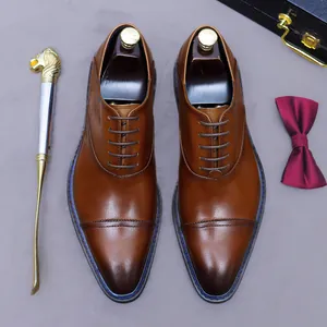 Classic brown leather Oxford cap-toe shoes for men in a professional business setting