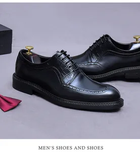 Detail of men's black leather brogue shoes with crocodile texture and classic lace-up style