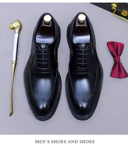 Detailed top view of black leather brogue shoes with decorative wingtip carvings and laces