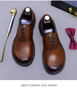 Overhead view of brown leather Oxford shoes with wide round toe and brogue details