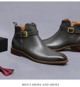 Detailed side view of grey leather dress boots with buckle strap and zipper closure