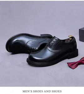 Detail view of men's black leather brogue shoes with wingtip detailing and dress accessories