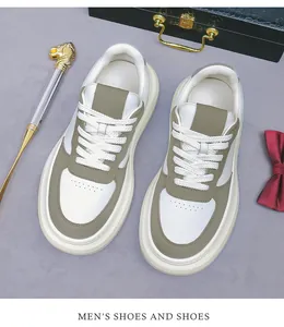 Close-up of white leather men's sneakers with olive green accents and thick platform soles