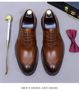 Close-up of brown leather wingtip brogue shoes with elegant decorative dress accessories