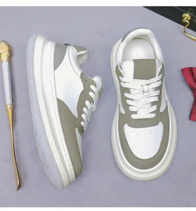 Detail of men's leather sneakers in white and olive green with a thick platform sole